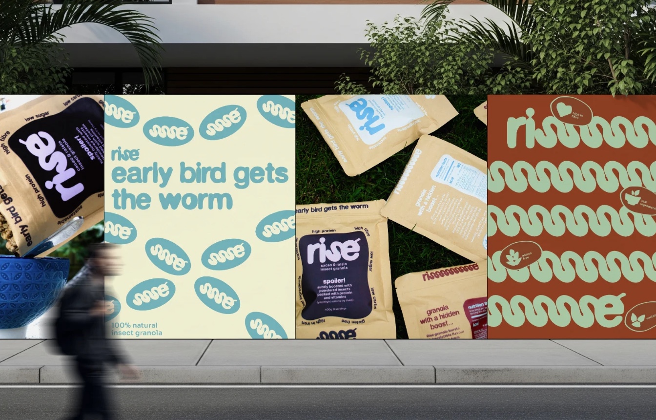 A row of rise street posters on a hoarding with a passer-by