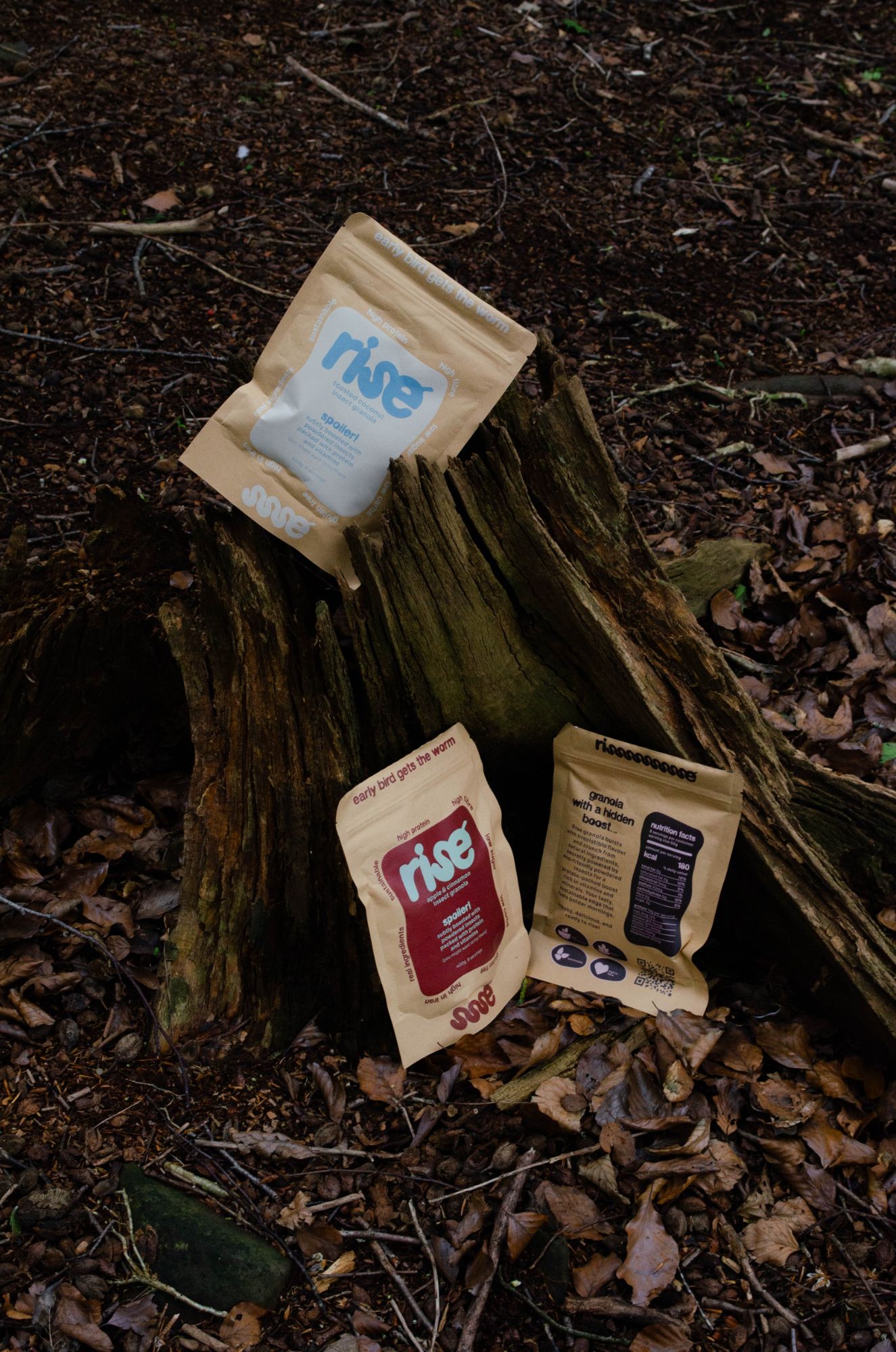 rise pouches propped against a tree stump on the forest floor